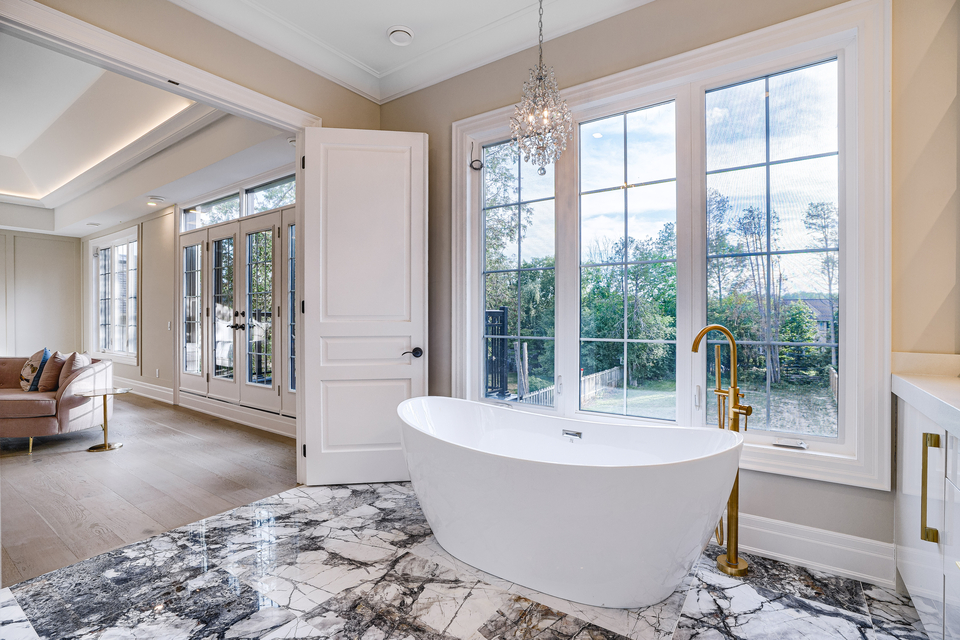 Bright white and black bathroom with freestanding tub